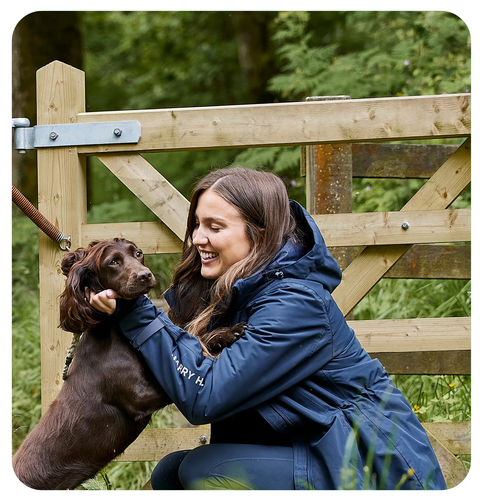 woman cuddling her brown dog